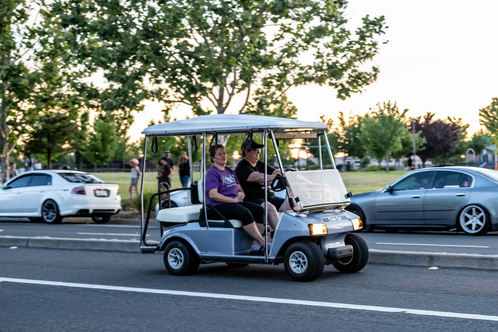 people riding on golf cart during daytime